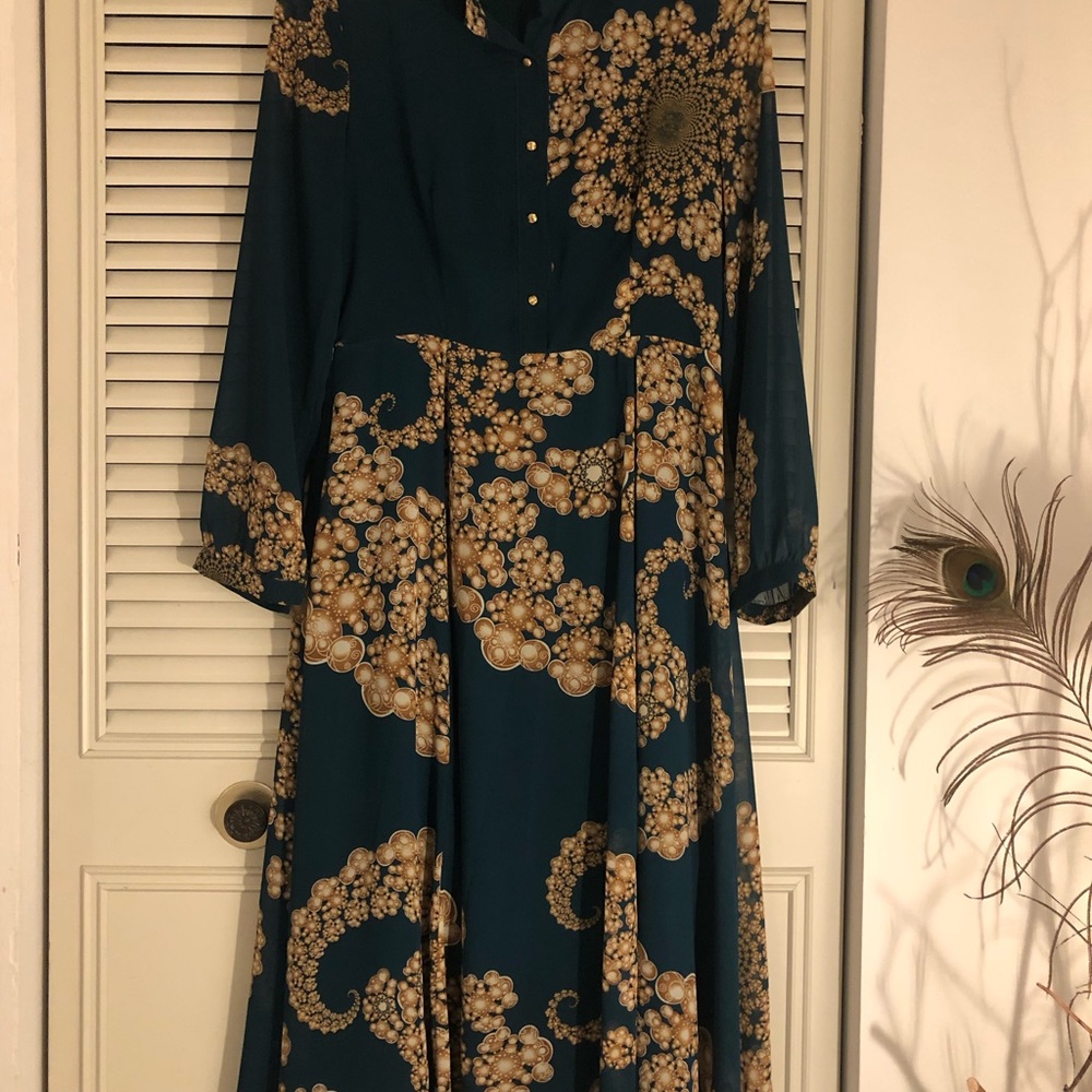 Stunning blue green with gorgeous designs. Very flattering and so feminine